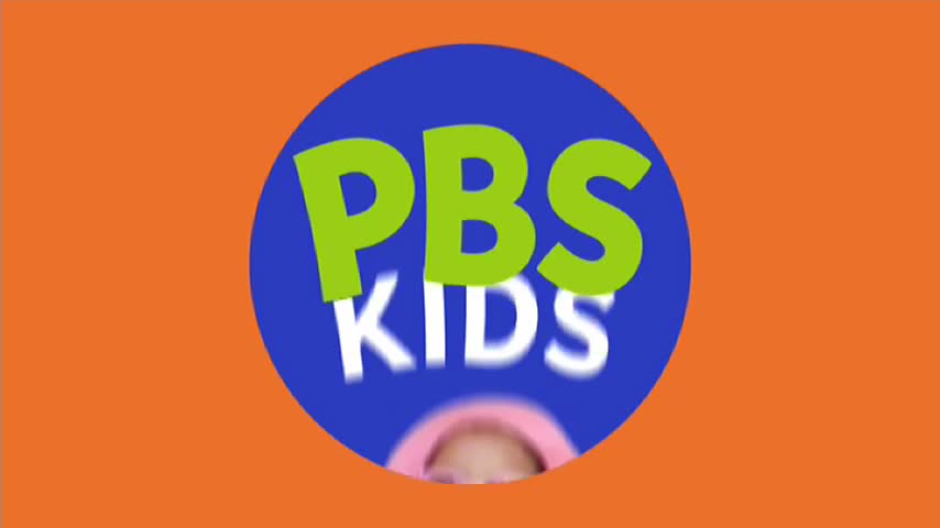 The PBS KIDS logo spins, the words blurring against the blue circle. Below, a child's face is visible, also blurred, as the logo rotates on the orange background.

