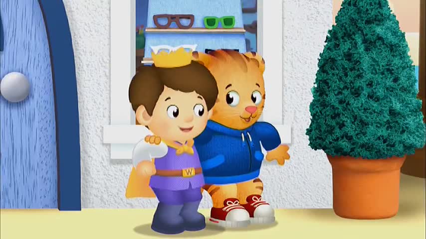 A tiger in a blue hoodie has his arm around a prince, both smiling. They are standing near a blue door and a potted topiary, probably from an episode of *Daniel Tiger's Neighborhood* on 10 Bold.
