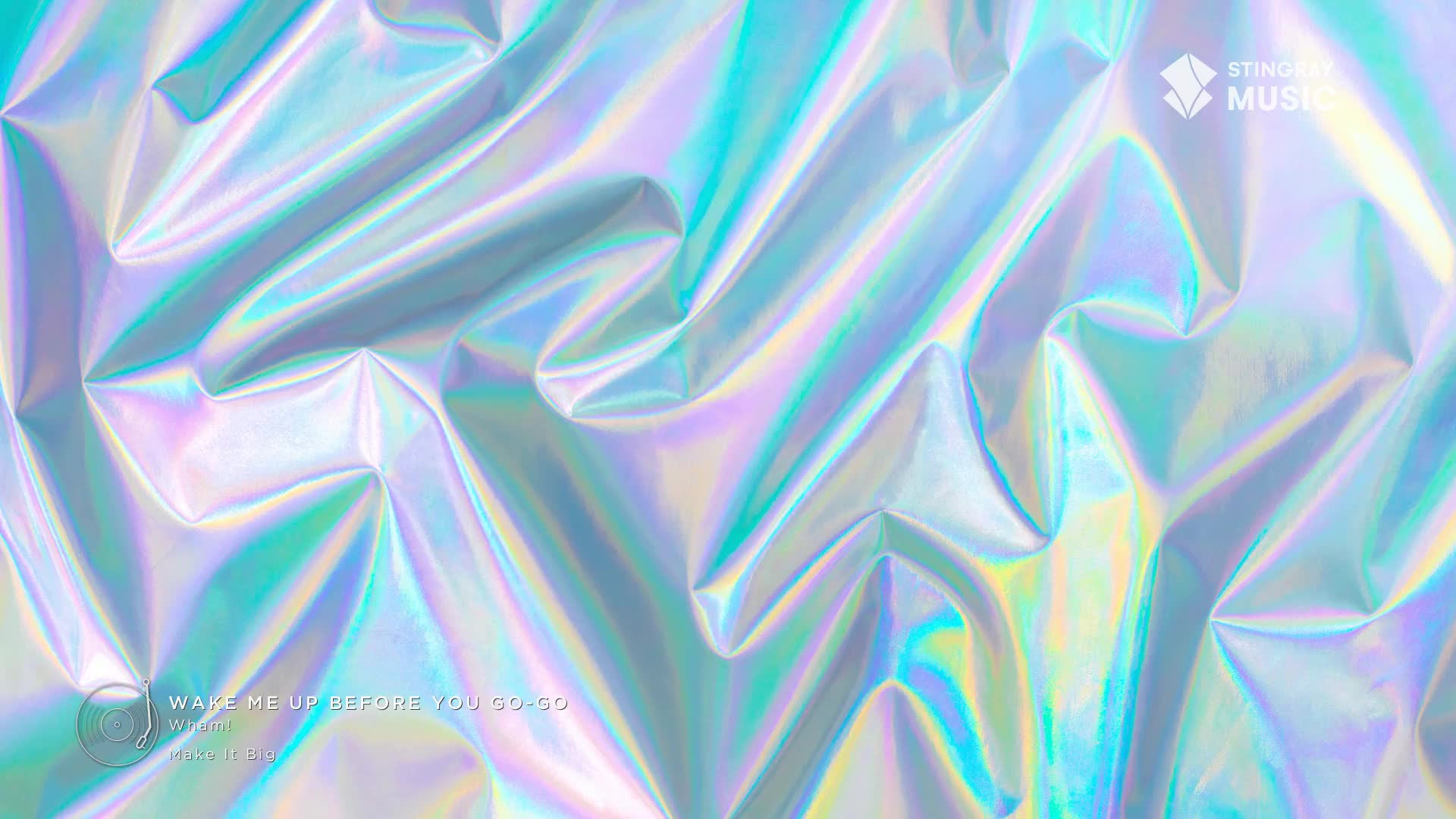 Iridescent fabric, creased and folded, reflects light in shimmering blues and greens. The Stingray Music logo sits in the top right corner, a reminder of the retro tunes playing.
