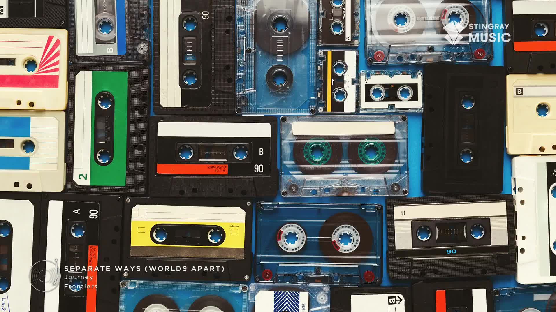 A collection of cassette tapes, in various colors and designs, are arranged tightly together. The Stingray Music logo and the title "Separate Ways (Worlds Apart)" are visible, a perfect soundtrack for a Canada-based Everything '80s playlist.
