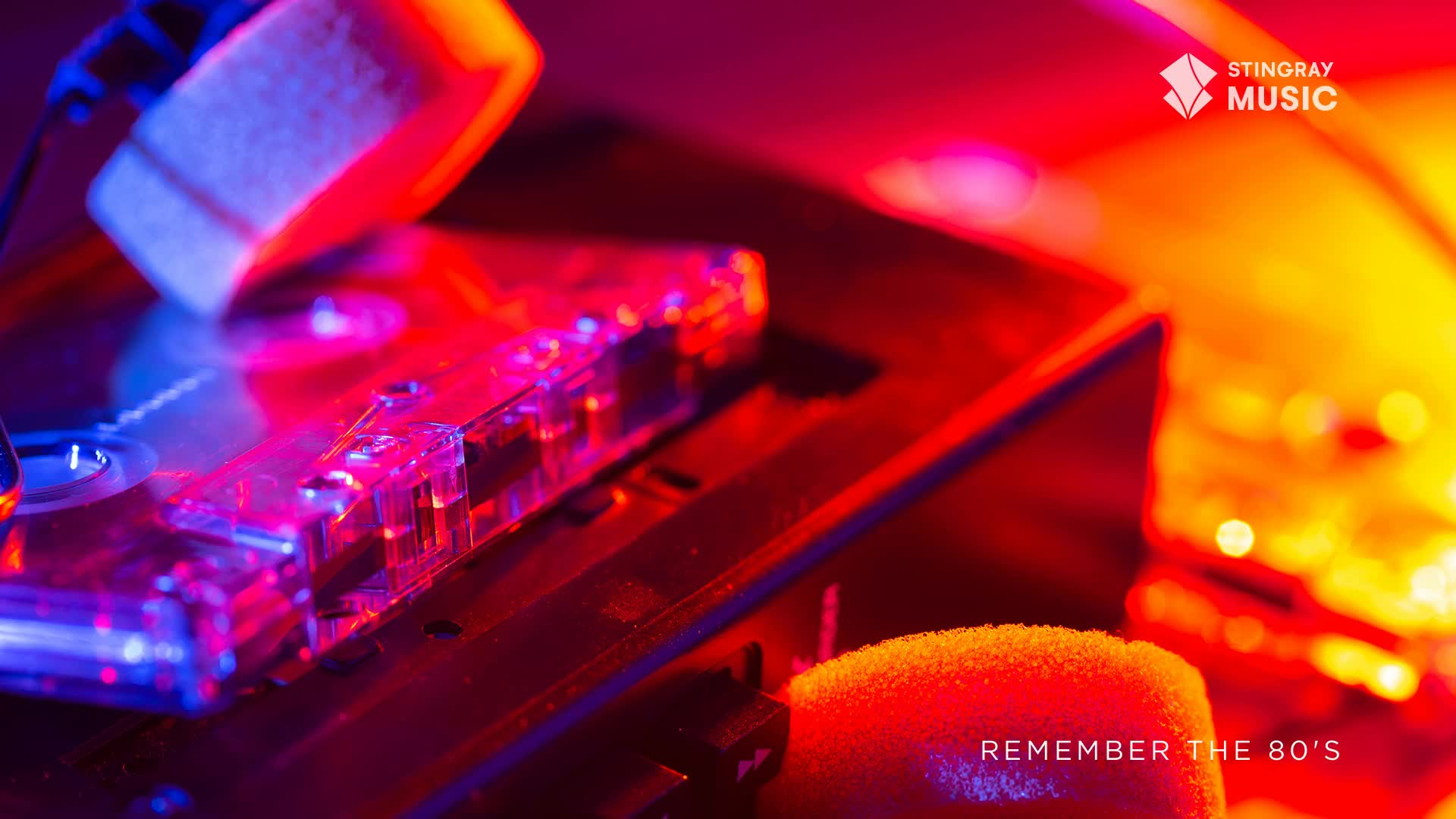 A clear cassette tape sits on a dark surface, bathed in red and blue light.  The "Remember the 80's" tagline, a nod to Stingray Everything '80s from Canada, is visible at the bottom.
