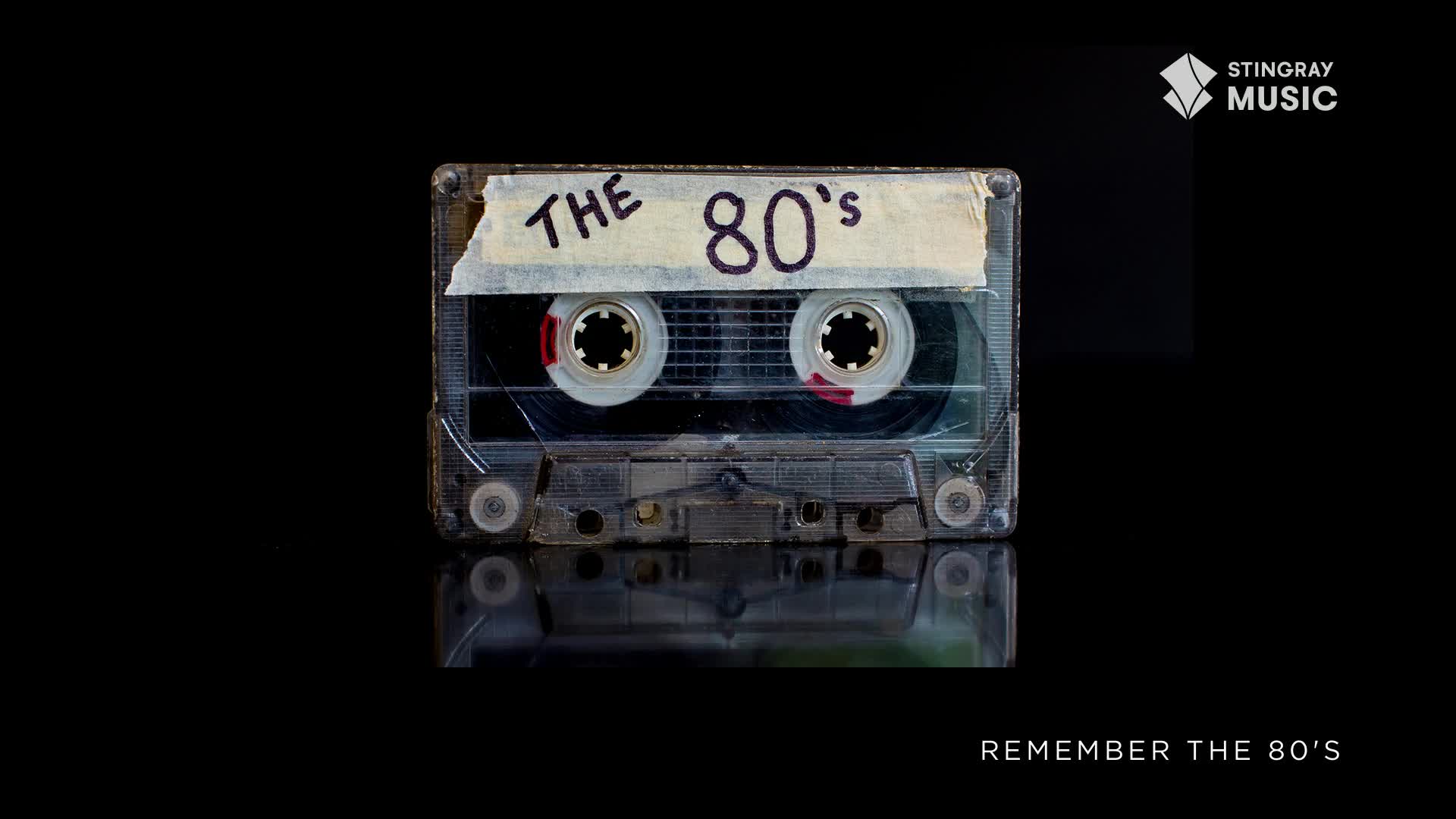 A clear cassette tape, labeled "THE 80's" with masking tape, sits on a reflective surface. The Stingray Music logo is in the upper right corner, reminding me of Canada's Everything '80s station.
