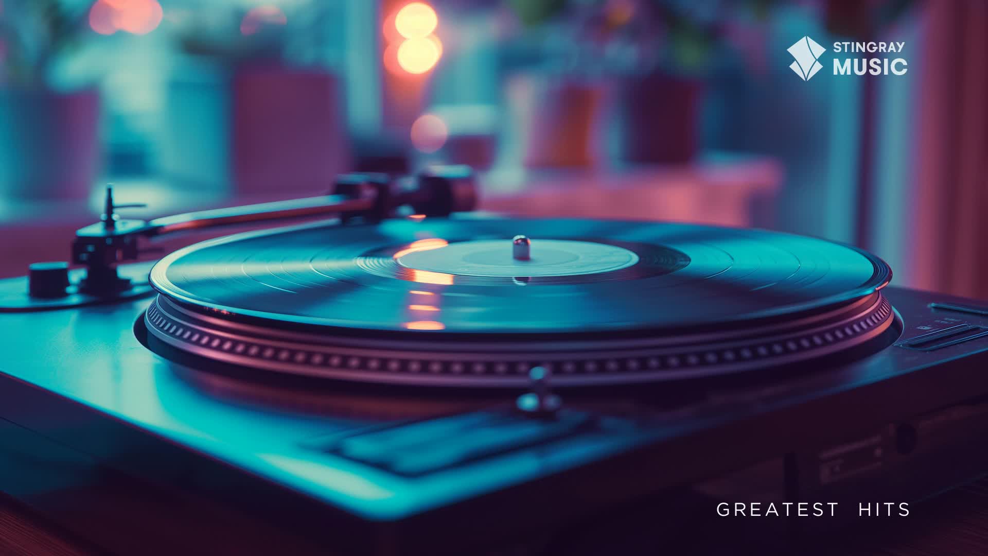 A record spins on a turntable, bathed in cool blue light. The Stingray Music logo and "Greatest Hits" text suggest the sounds of Canada's holiday hits are about to fill the room.
