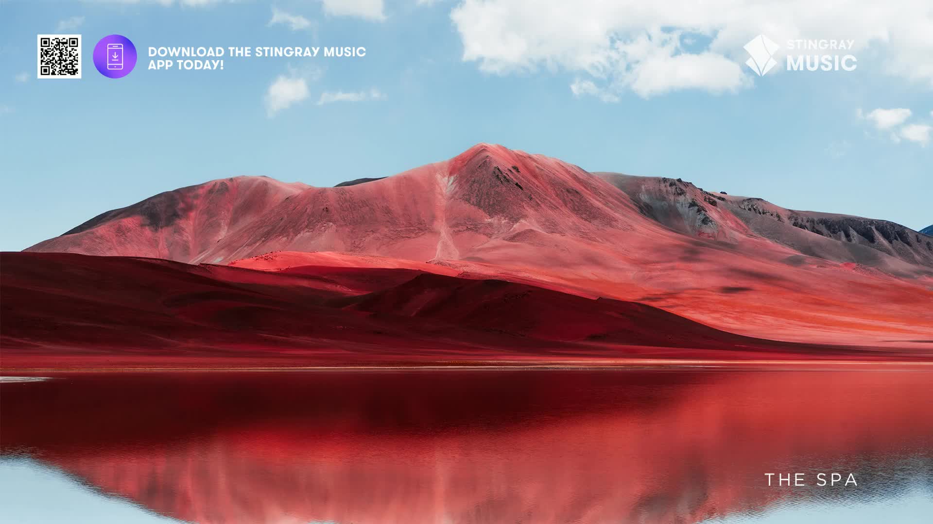 The vast, red-tinged mountains rise behind a still, blood-red lake. This Canadian landscape, a scene reminiscent of a spa's tranquil beauty, reflects the sky and peaks in its glassy surface.