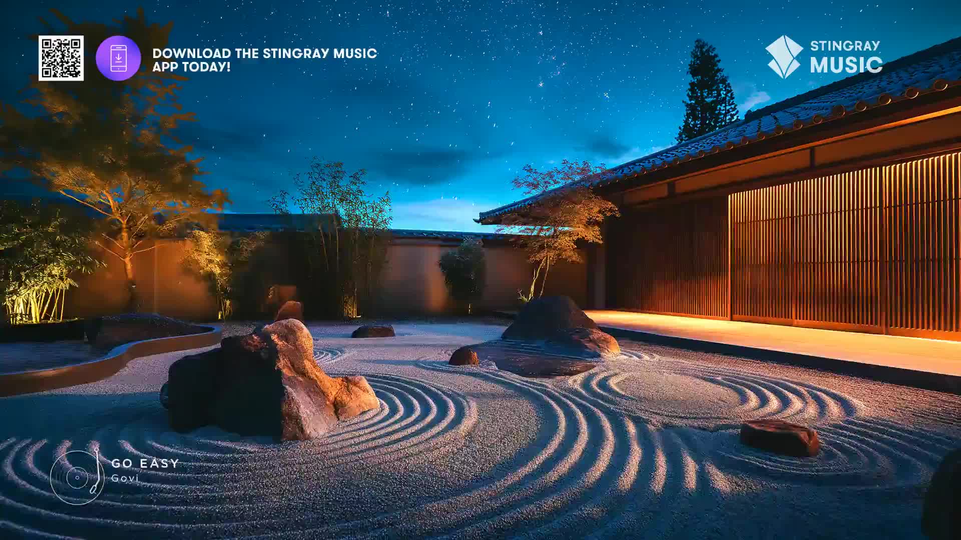 The night sky above is a deep blue, dotted with stars. A Japanese garden, raked with precise lines in the sand, is illuminated by soft, warm lights. The air feels still and peaceful, like at a spa in Canada.