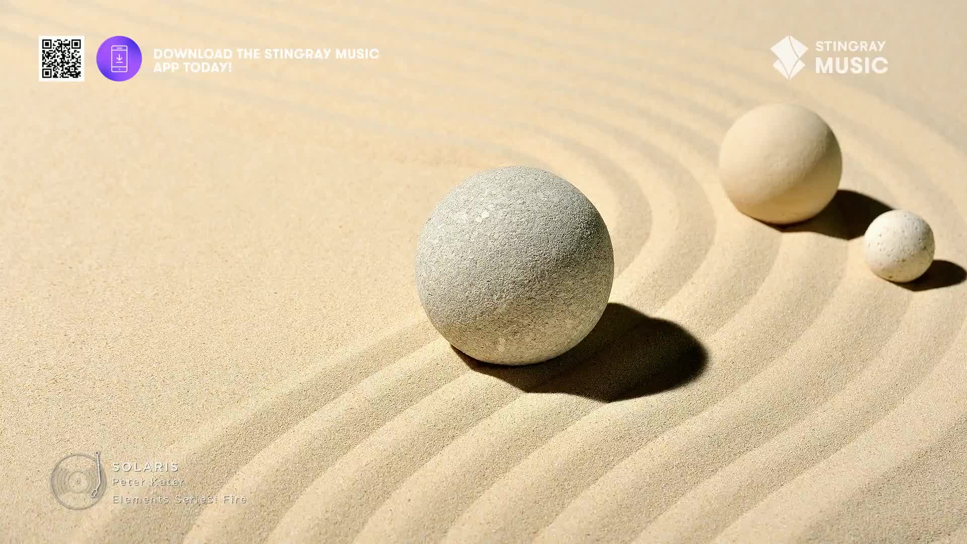 Three smooth stones sit on raked sand, their shadows stretching across the gentle waves. This scene evokes the calm of a spa, a moment of quiet contemplation.