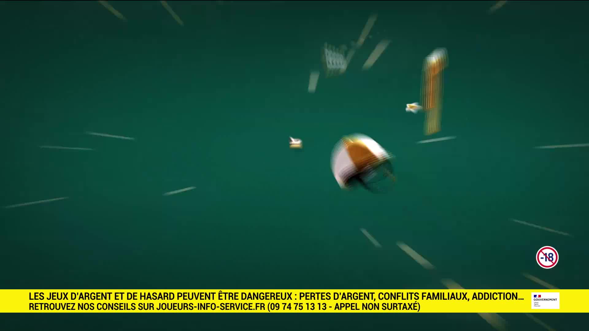A white and orange ball spins past, leaving streaks of light against the green background. A tall, thin orange object also moves rapidly in the distance.