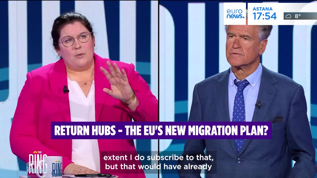 A woman in a bright pink blazer gestures with her right hand as she speaks, while a man in a blue suit looks on. A graphic overlay reads "RETURN HUBS - THE EU'S NEW MIGRATION PLAN?".