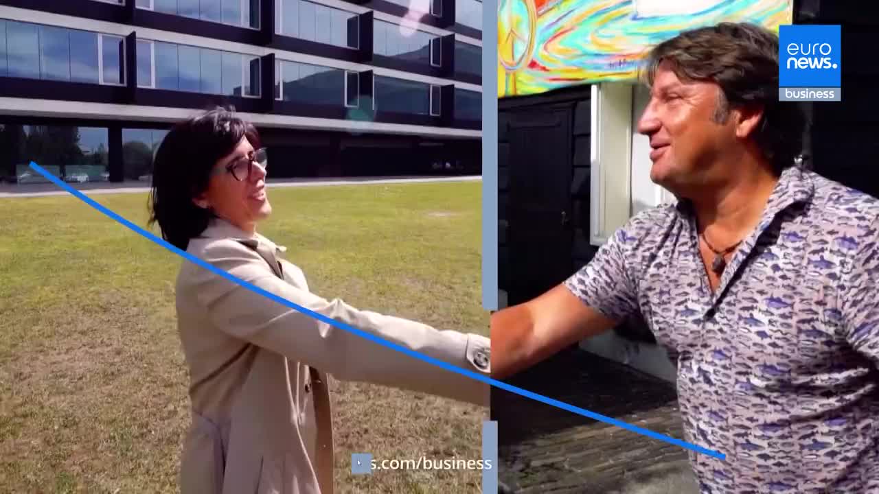 A woman in a tan trench coat extends her hand, smiling, as a man in a patterned shirt reaches out to meet her. The backdrop suggests a split screen, with the woman in front of a modern building and the man near a colorful mural.