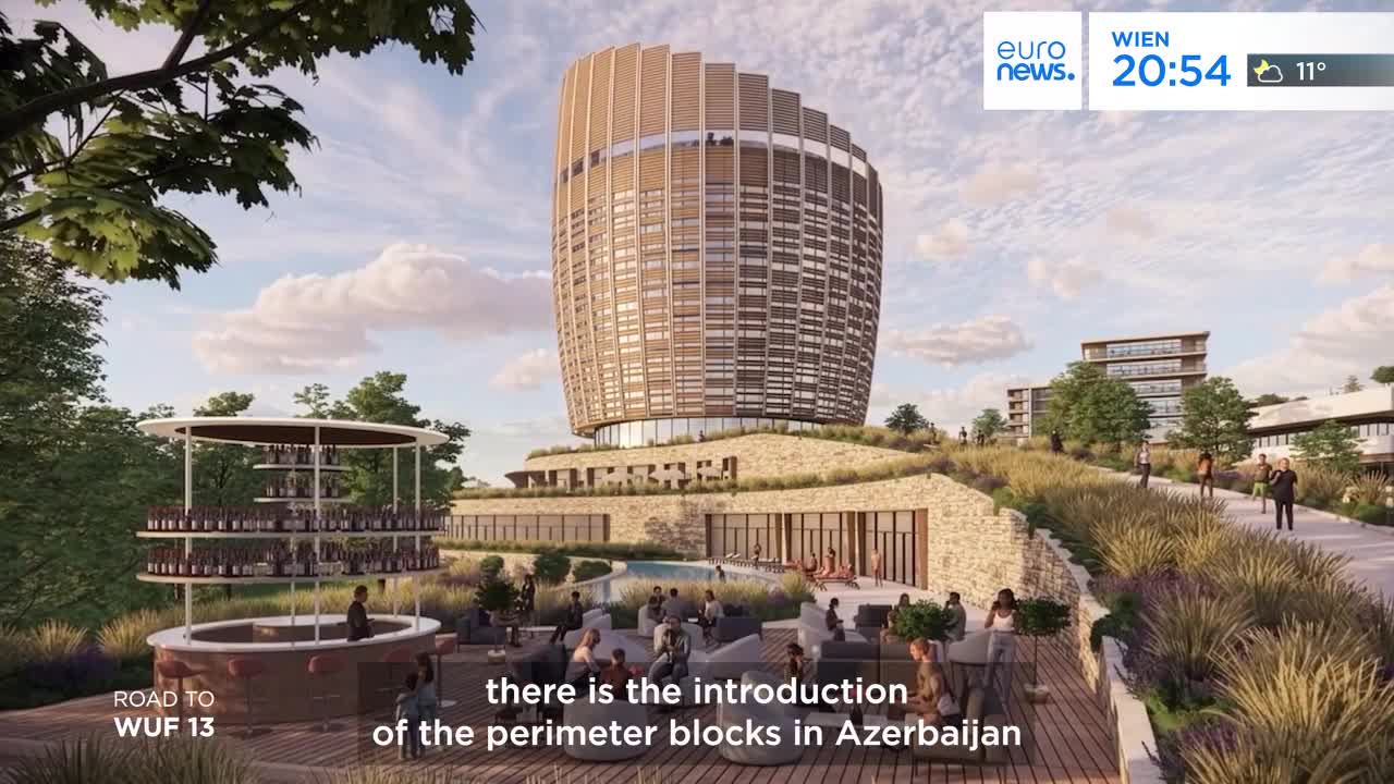 People stroll along a path leading to a modern complex of buildings, with a distinctive cylindrical tower dominating the skyline. Below, a lively outdoor bar area buzzes with activity, and a pool area offers a place to relax.