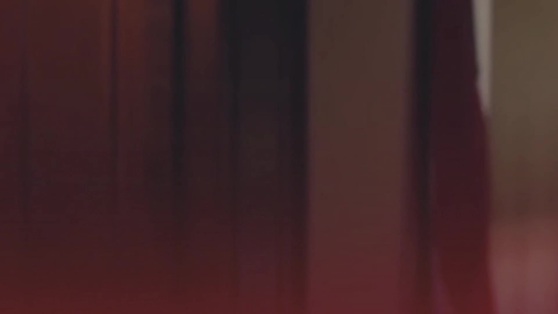 The train is pulling away from the station, its dark carriages sliding past the platform. A faint red glow from the tail lights streaks the scene as it disappears into the distance.