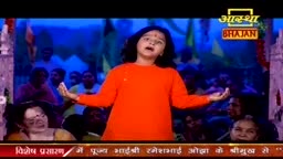 A young performer in an orange kurta sings with open arms, her face tilted upwards. An audience watches from the dim background, their faces illuminated by the stage lights.