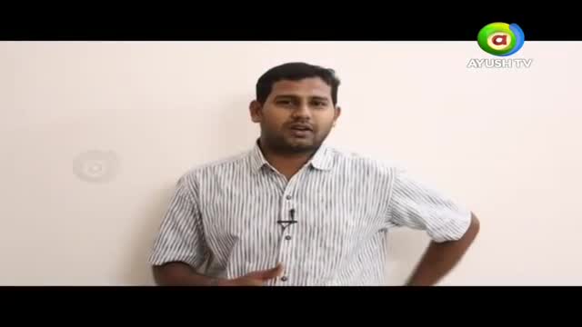 A man in a striped shirt stands before a plain wall, speaking directly to the camera. The Ayush TV logo is visible in the upper right corner.
