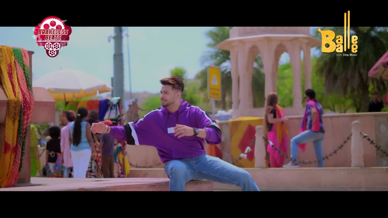 A man in a purple hoodie is mid-dance, his arms extended. Behind him, a vibrant market buzzes with people in colorful Indian attire, and a Balle Balle logo gleams.
