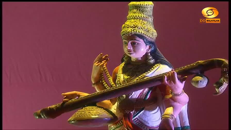 A statue of Saraswati, the goddess of music, holds a veena. The DD Malayalam logo appears in the corner. A statue of Saraswati, the goddess of music, holds a veena. The DD Malayalam logo appears in the corner.