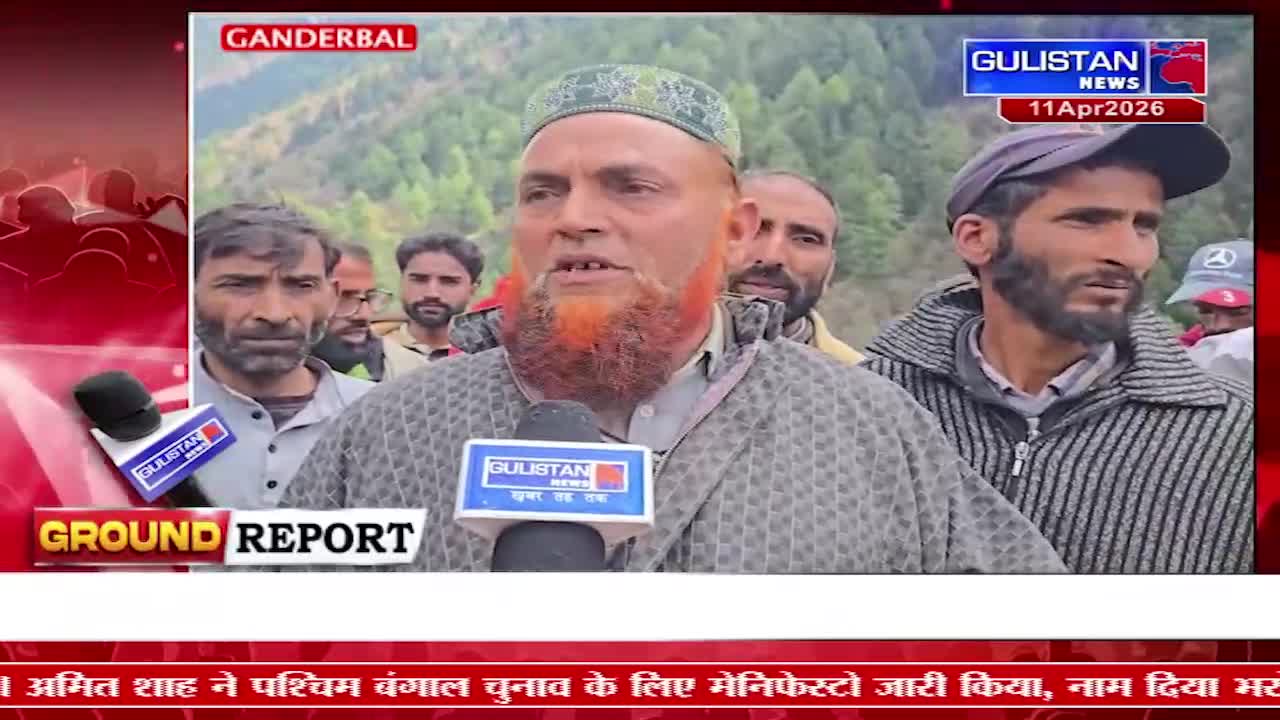 A man with a bright orange beard speaks into a Gulistan News microphone, surrounded by other men in a mountainous region. The Gulistan News chyron identifies the location as Ganderbal.