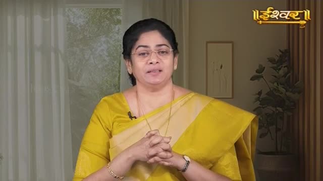 A woman in a bright yellow sari speaks, her hands clasped before her. The Ishwar logo appears in the upper right corner.