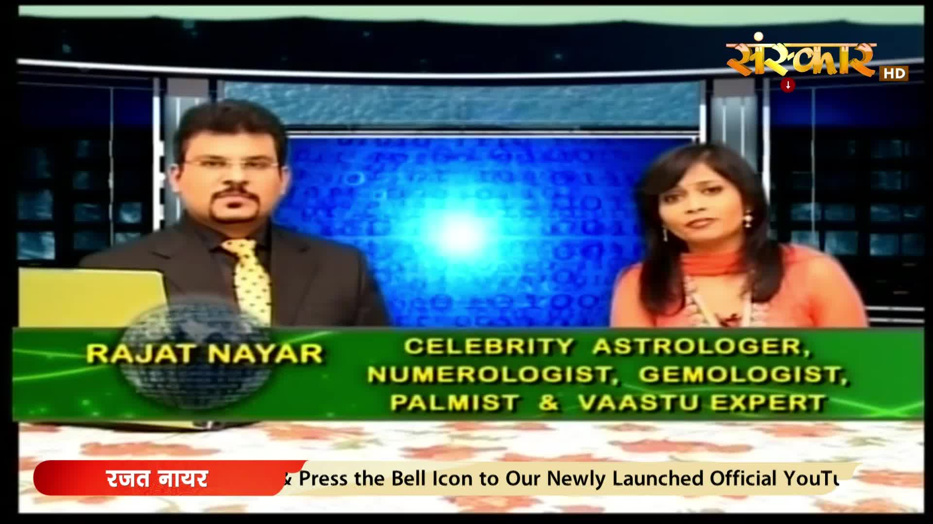 A man in a suit and tie sits to the left, while a woman in an orange outfit is on the right. A green banner below them displays "Rajat Nayar" and lists "Celebrity Astrologer, Numerologist, Gemologist, Palmist & Vaastu Expert."