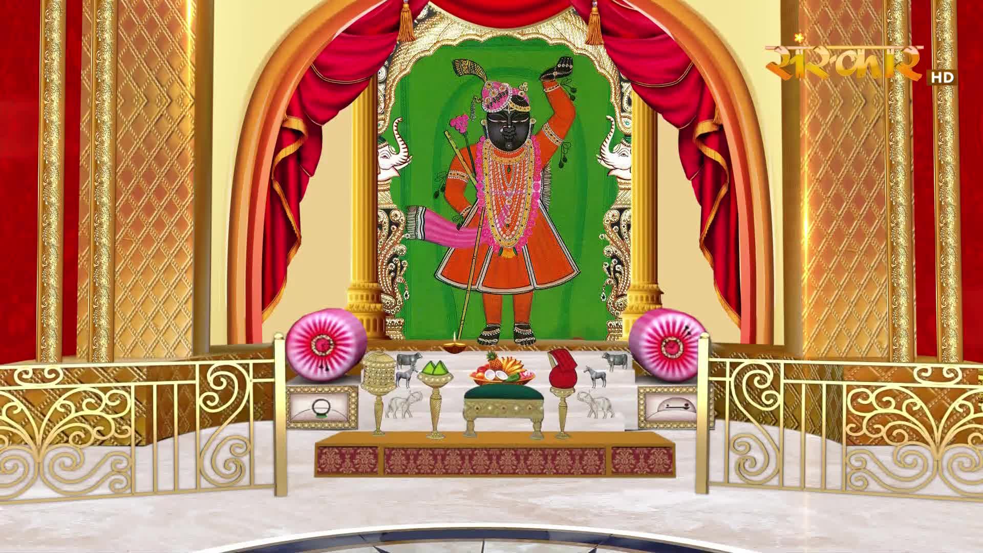 Before me, a vibrant depiction of a deity stands within an ornate shrine, draped with rich red curtains.  The Sanskar TV logo is visible in the upper right corner.