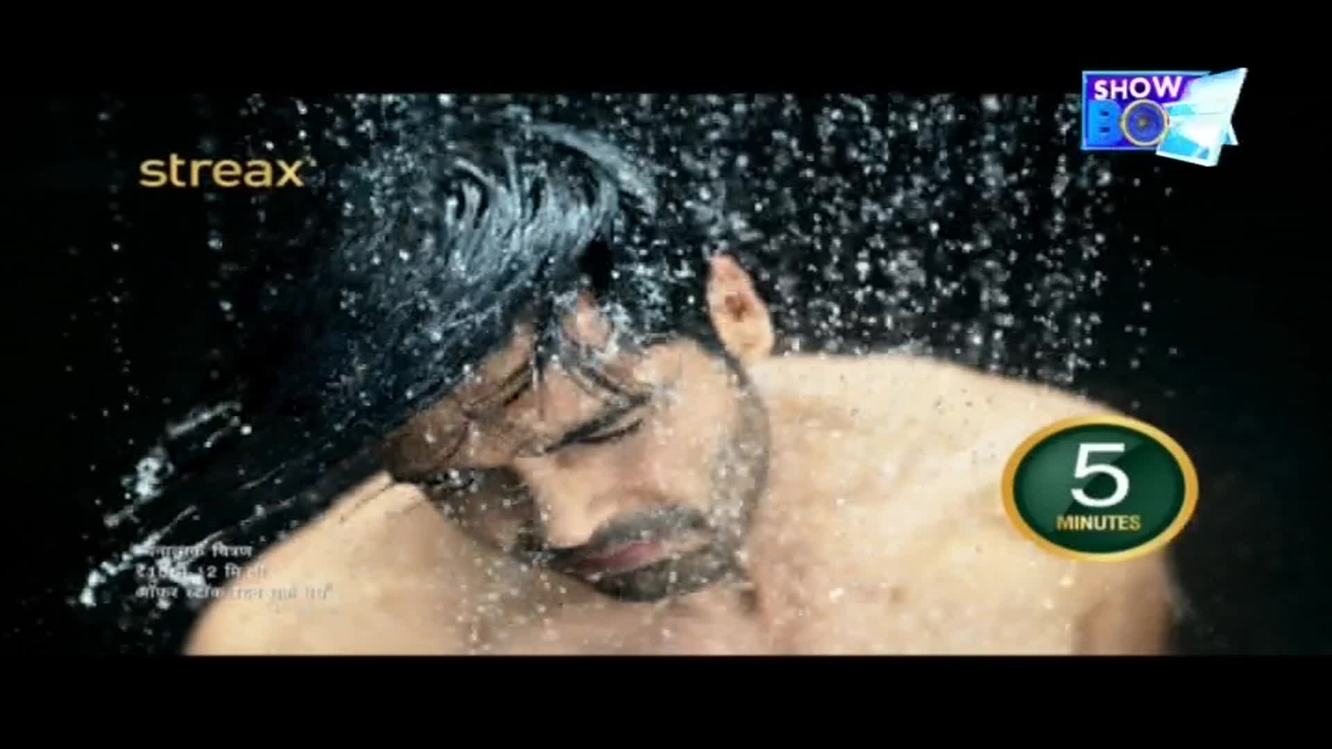 Water cascades over a man's dark hair, droplets scattering across his face. A "ShowBox" logo and a "5 minutes" timer sit in the corner, as if this is a commercial from India.
