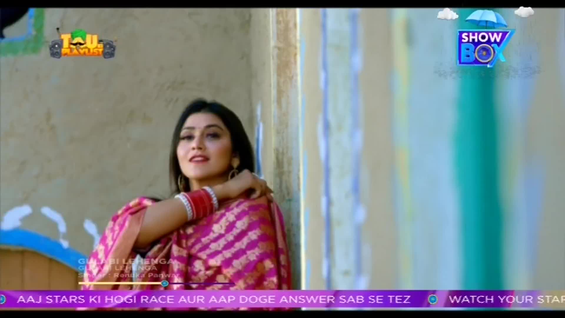 A woman in a pink sari smiles, her arm resting gently on her shoulder. The ShowBox logo and text in Hindi are visible in the corner.
