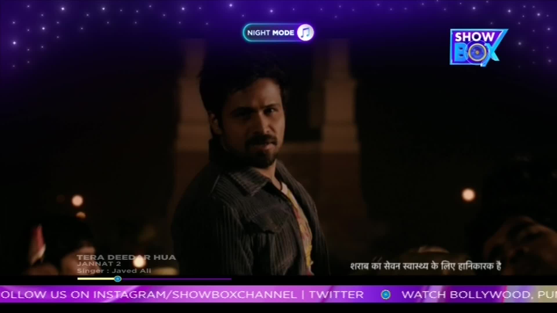 A man with a beard looks intensely into the camera, his expression serious. The ShowBox logo is visible in the upper right corner, and a Hindi warning about alcohol consumption appears at the bottom. A man with a beard looks intensely into the camera, his expression serious. The ShowBox logo is visible in the upper right corner, and a Hindi warning about alcohol consumption appears at the bottom.