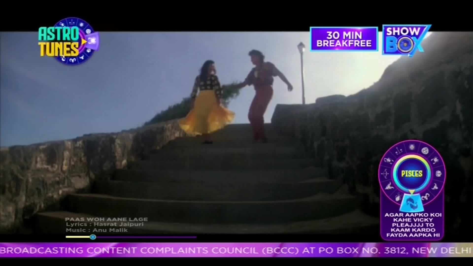 A man in red pants and a woman in a flowing yellow skirt dance up a stone staircase. Their movements are lively, and the woman's skirt swirls with each step. A man in red pants and a woman in a flowing yellow skirt dance up a stone staircase. Their movements are lively, and the woman's skirt swirls with each step.