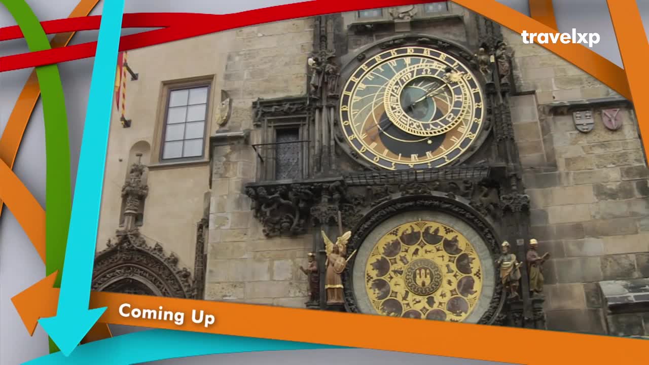 The intricate astronomical clock on the Old Town Hall is the centerpiece of this view. Colorful arrows frame the scene, hinting at upcoming segments from Travelxp. The intricate astronomical clock on the Old Town Hall is the centerpiece of this view. Colorful arrows frame the scene, hinting at upcoming segments from Travelxp.