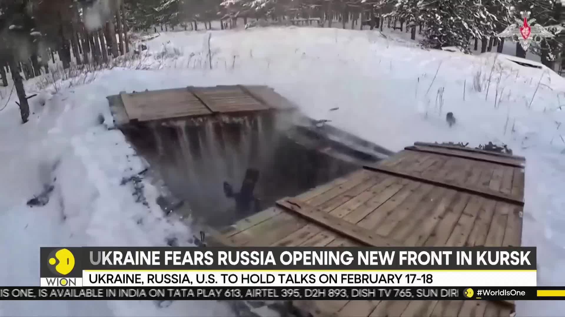 A person scrambles down into a snow-covered trench, disappearing beneath wooden planks. Smoke billows from the opening, hinting at recent activity.