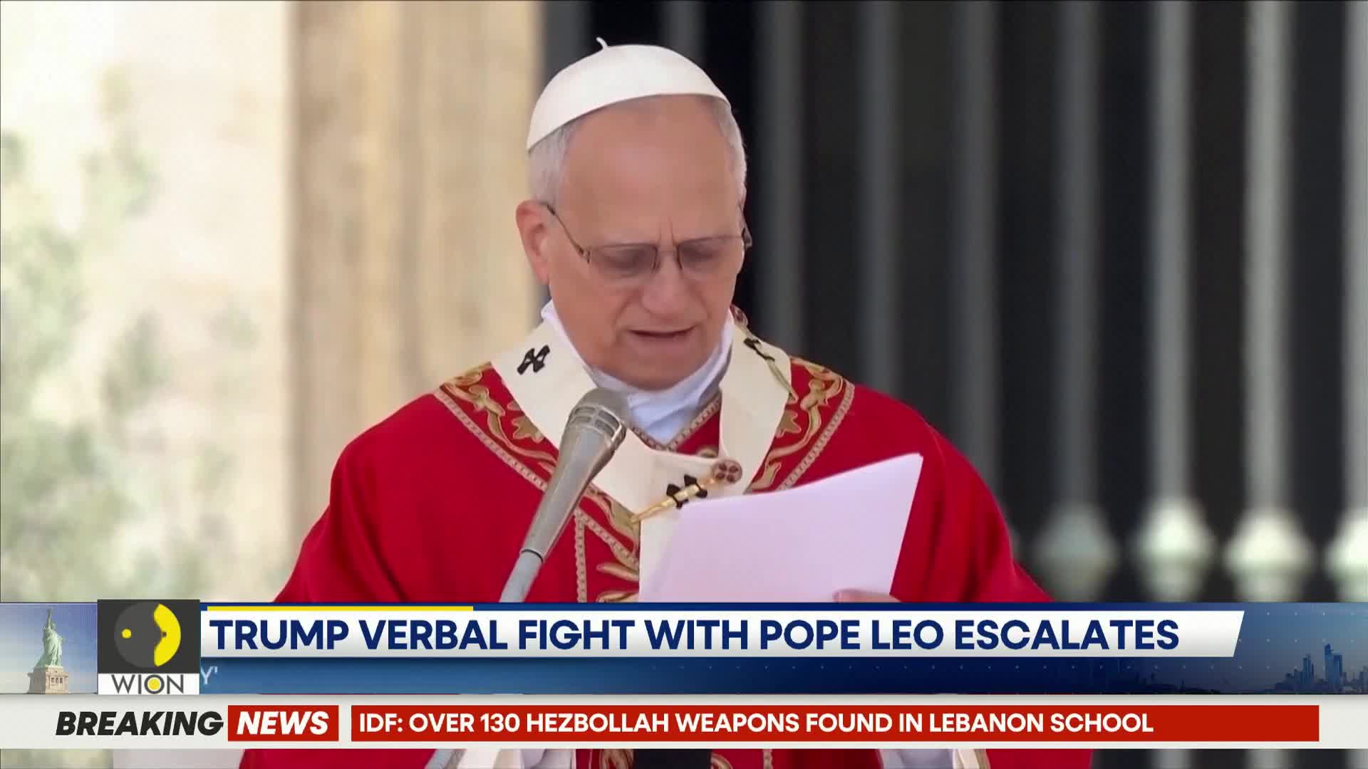 A man in a white skullcap and red vestments stands at a microphone, holding a document. A news ticker at the bottom of the screen reads "TRUMP VERBAL FIGHT WITH POPE LEO ESCALATES."