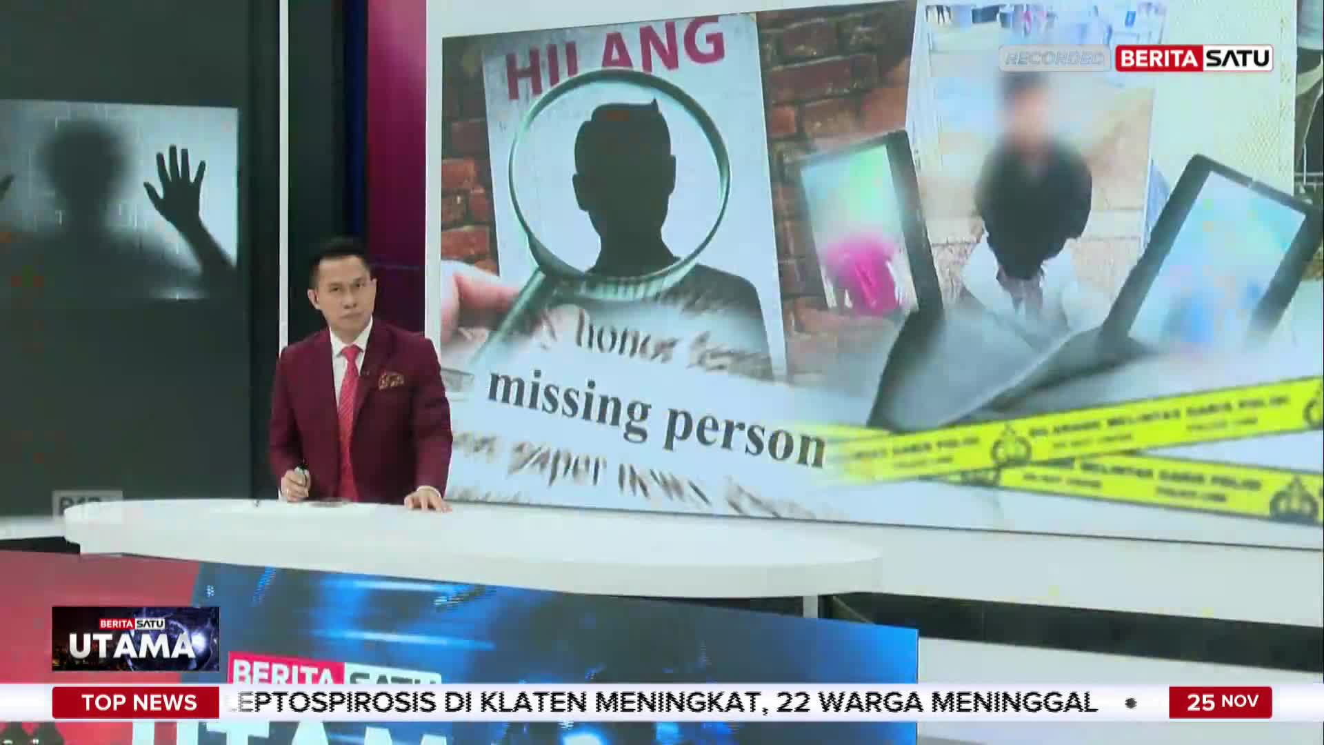 A news anchor in a maroon suit stands at a desk, facing the camera with a serious expression. Behind him, a screen displays images related to a missing person case, as reported by BeritaSatu English from Indonesia.
