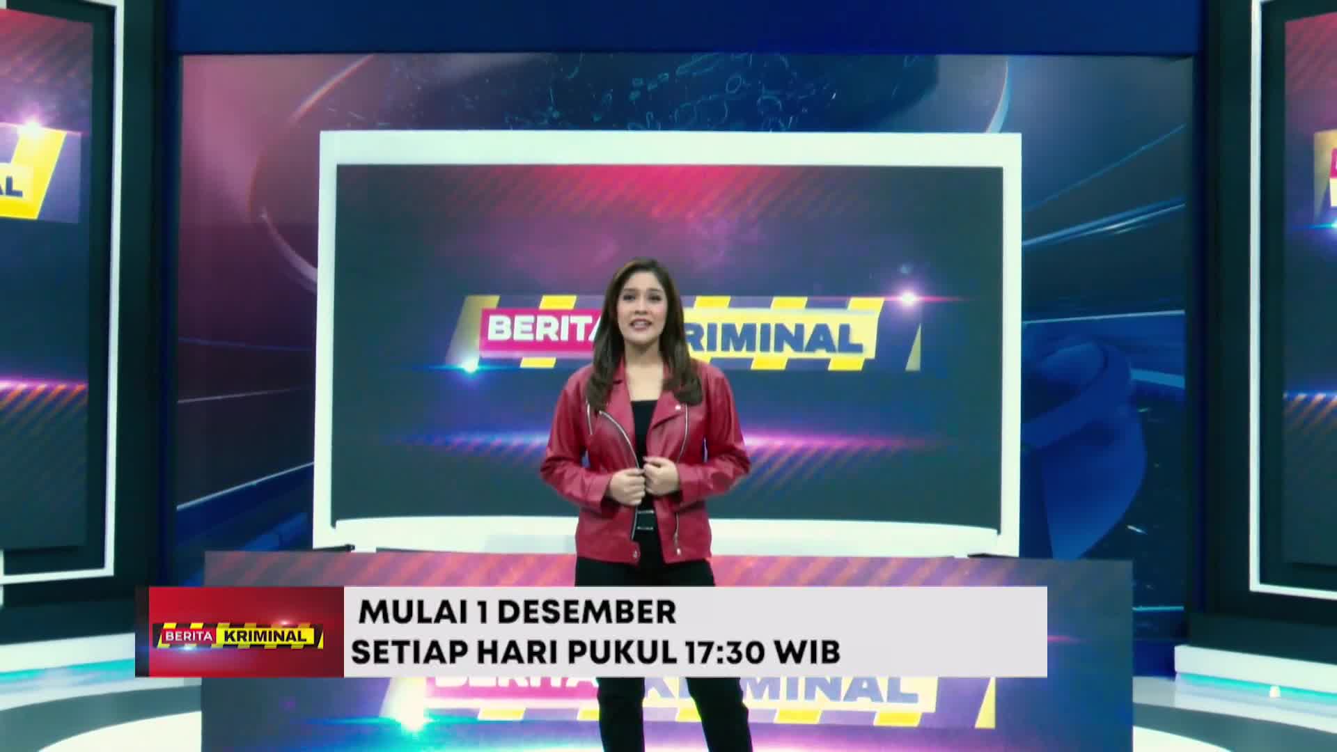 A woman in a red jacket stands in front of a large screen, smiling at the camera. The BeritaSatu English program "Berita Kriminal" is about to begin.
