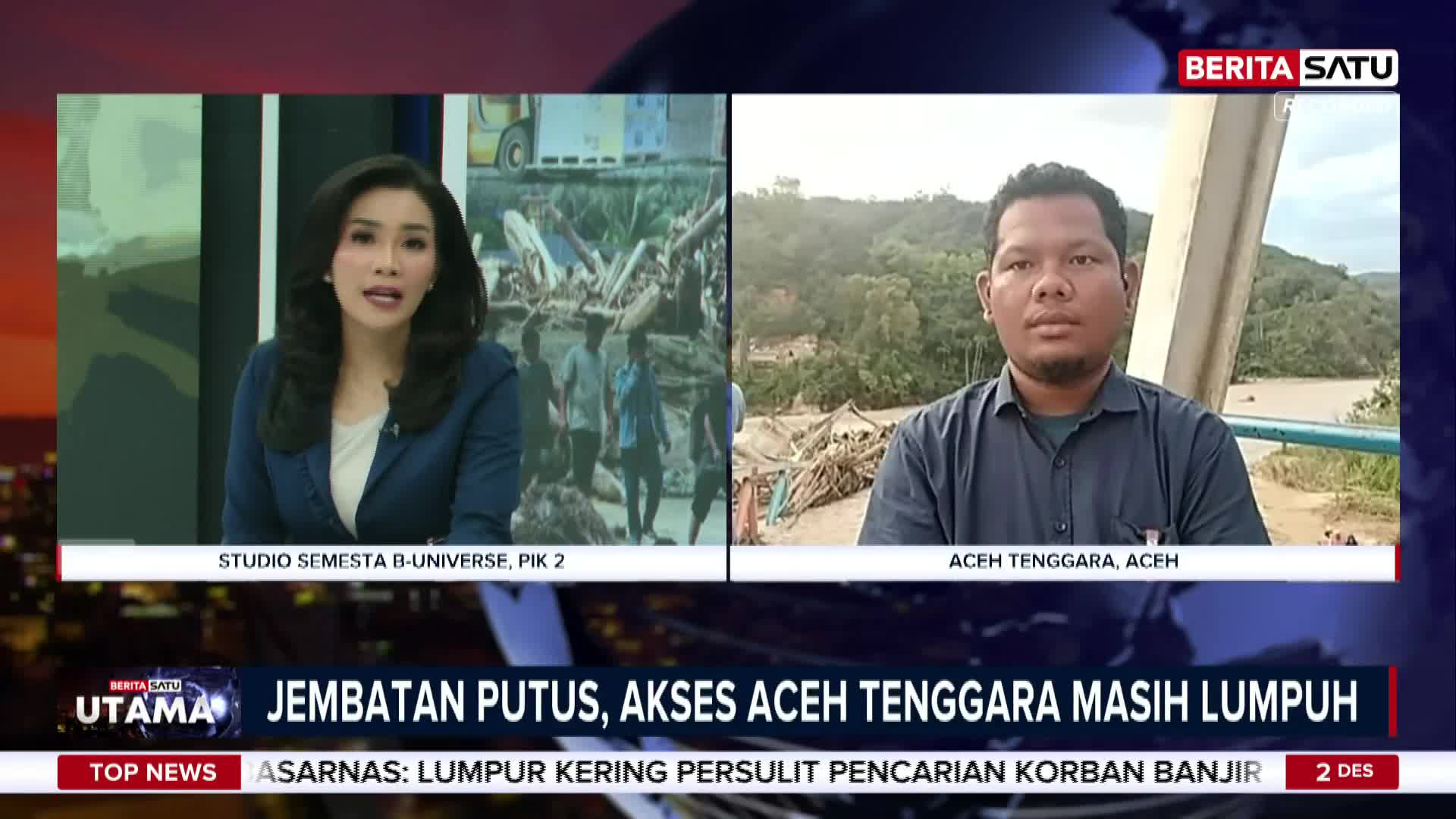 A news anchor in a blue blazer speaks from a studio, while a man in a button-down shirt reports from Aceh Tenggara, Indonesia. The BeritaSatu English broadcast covers the aftermath of a disaster, with the headline "Broken Bridge, Access to Aceh Tenggara Still Paralysed."
