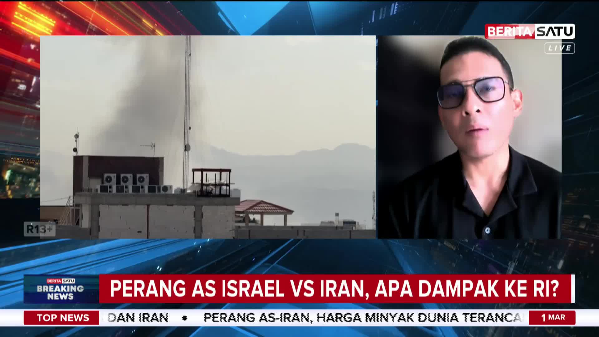 Thick, dark smoke billows into the hazy sky from a building's rooftop. A man in glasses speaks directly to the camera, his face framed by a black shirt. Thick, dark smoke billows into the hazy sky from a building's rooftop. A man in glasses speaks directly to the camera, his face framed by a black shirt.