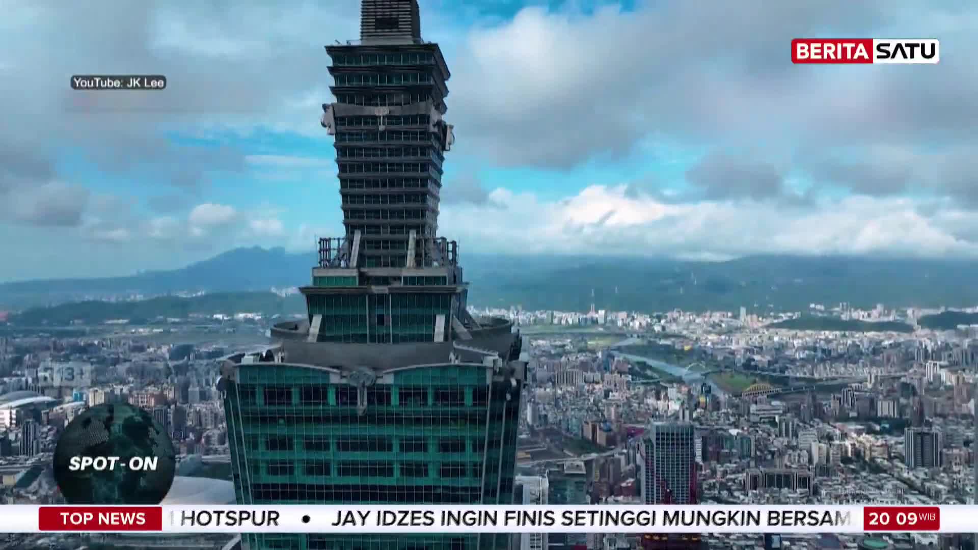 A massive skyscraper dominates the view, its dark, tiered structure reaching into a sky filled with dramatic clouds. Below, a sprawling city unfolds, a dense tapestry of buildings stretching towards distant mountains. A massive skyscraper dominates the view, its dark, tiered structure reaching into a sky filled with dramatic clouds. Below, a sprawling city unfolds, a dense tapestry of buildings stretching towards distant mountains.