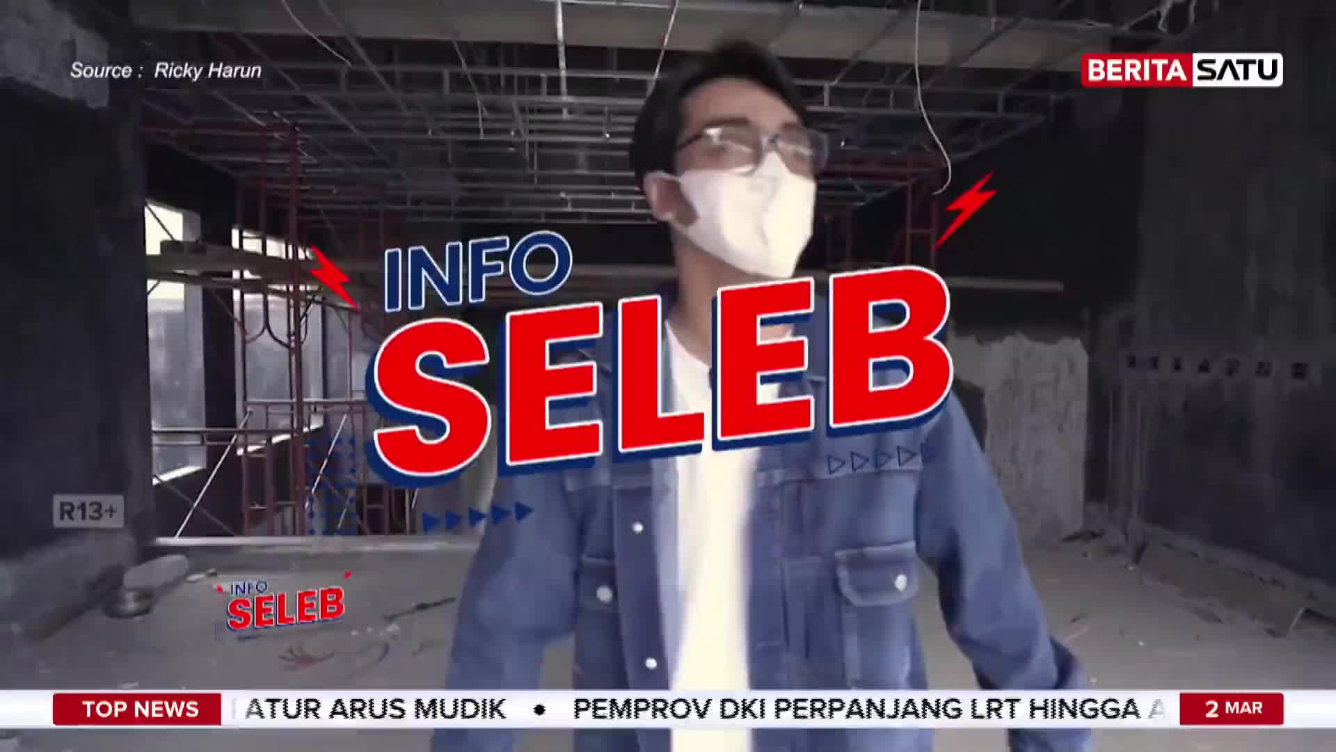 A young man in a denim jacket and mask walks through a construction site. The BeritaSatu logo is visible in the corner. A young man in a denim jacket and mask walks through a construction site. The BeritaSatu logo is visible in the corner.