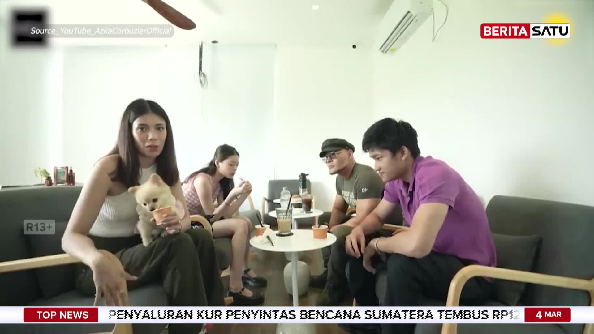 A woman holds a small, fluffy dog while sitting on a couch. Across from her, three men and another woman are gathered around a coffee table. A BeritaSatu logo is visible in the upper right corner. A woman holds a small, fluffy dog while sitting on a couch. Across from her, three men and another woman are gathered around a coffee table. A BeritaSatu logo is visible in the upper right corner.