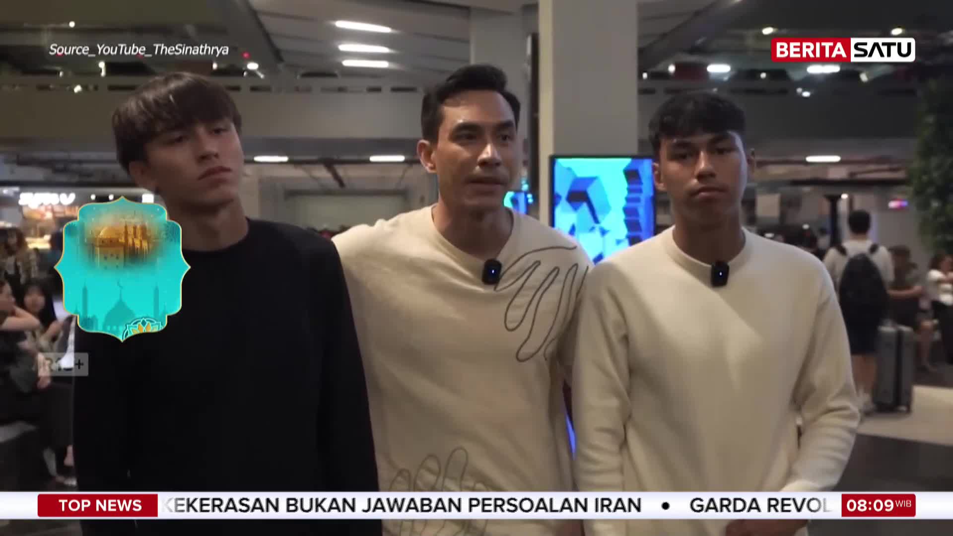 Three young men stand together, their expressions serious. Behind them, a BeritaSatu logo is visible, suggesting a news segment.