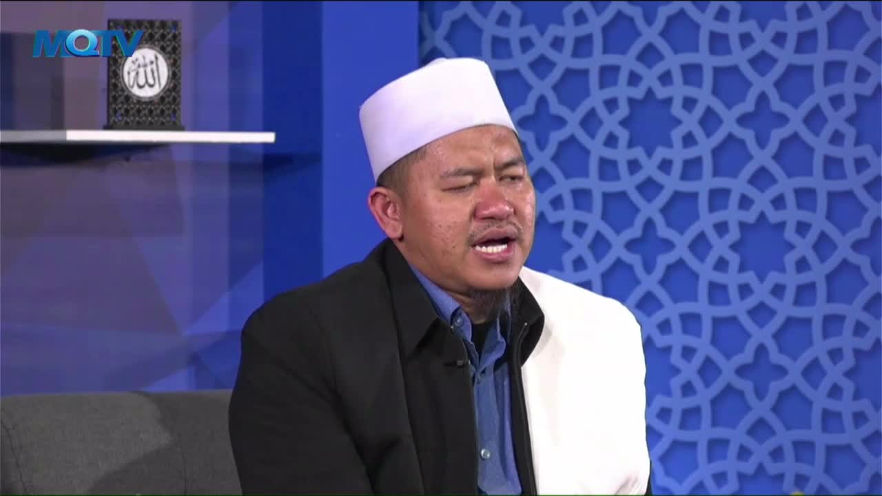The man, wearing a white cap, is speaking with conviction, his mouth open. He's on a set with a blue patterned backdrop, the MQTV logo visible in the corner.
The man, wearing a white cap, is speaking with conviction, his mouth open. He's on a set with a blue patterned backdrop, the MQTV logo visible in the corner.