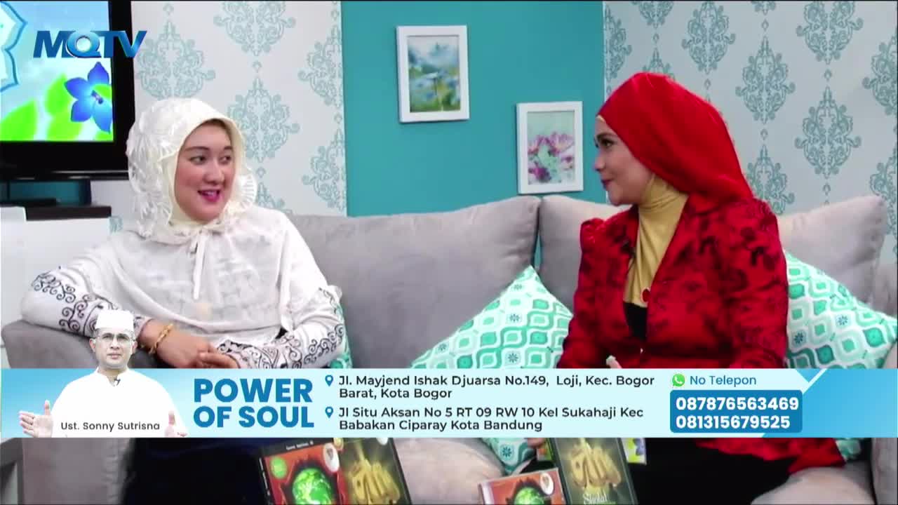 Two women, both wearing headscarves, are seated on a gray couch, engaged in conversation on an MQTV set. The "Power of Soul" logo and a picture of Ust. Sonny Sutrisno are visible in the lower third of the screen.
Two women, both wearing headscarves, are seated on a gray couch, engaged in conversation on an MQTV set. The "Power of Soul" logo and a picture of Ust. Sonny Sutrisno are visible in the lower third of the screen.