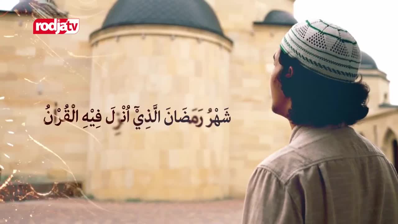 A man in a peci cap looks up towards a mosque, his gaze fixed on the Arabic script displayed on screen. The Rodja TV logo appears in the corner, a familiar sight during Ramadan in Indonesia.