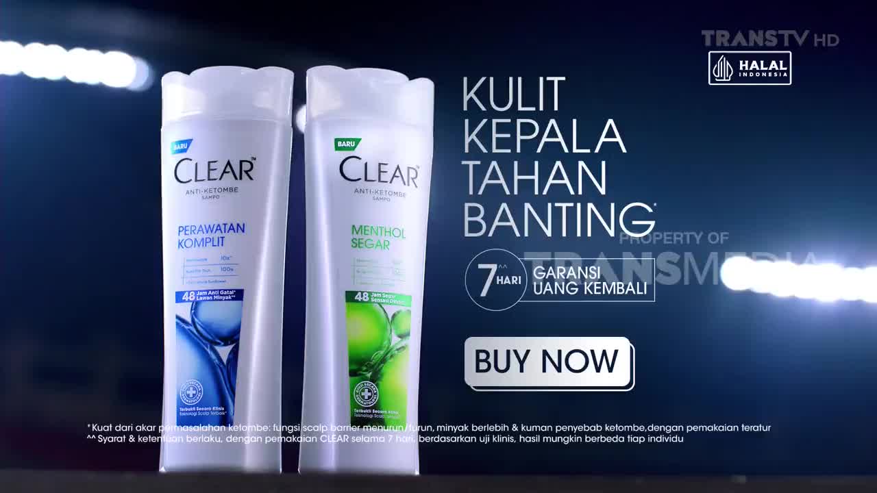 Two bottles of Clear shampoo stand side-by-side against a dark, glowing background. A bright white light streaks across the screen, illuminating the Trans TV logo.