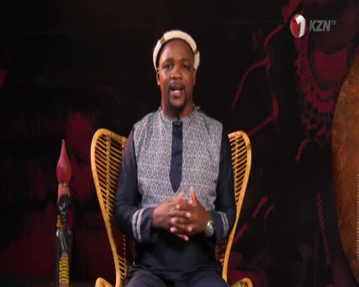 A man in traditional South African attire sits in a woven chair, speaking into a microphone. The KZN TV logo appears in the corner of the screen.