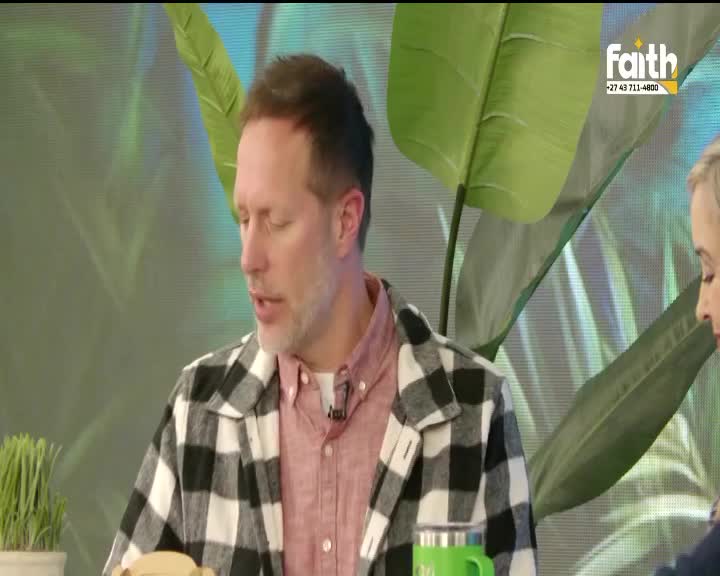 A man in a checkered shirt speaks earnestly, his gaze directed off-camera. Behind him, a large green leaf and the Faith TV logo frame the scene.