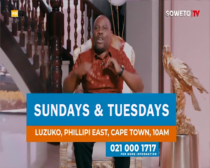 A man in a red patterned shirt gestures emphatically while seated on a grand chair. A golden eagle statue stands guard beside him.