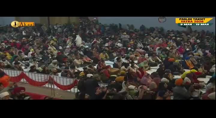 A large crowd sits on the floor, many wearing turbans, watching something out of view. The Akaal Channel logo is visible, and a banner advertises the Panjh Takht Yatra 2026.
