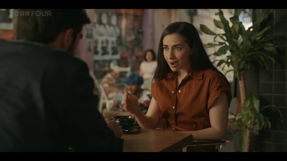 A woman in a rust-coloured shirt gestures emphatically as she speaks, her expression animated. The BBC Four logo appears in the corner of the screen, indicating a broadcast from the United Kingdom.