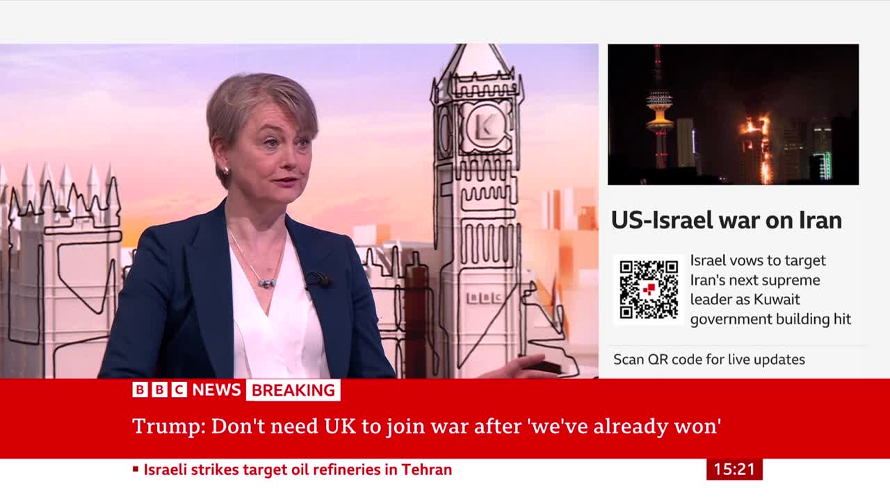 A woman in a dark suit speaks on BBC News, with a graphic of Big Ben behind her. To the right, a news ticker displays "US-Israel war on Iran" and a breaking news headline about Israeli strikes. A woman in a dark suit speaks on BBC News, with a graphic of Big Ben behind her. To the right, a news ticker displays "US-Israel war on Iran" and a breaking news headline about Israeli strikes.