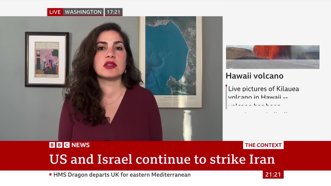 A woman in a maroon top speaks directly to the camera. A graphic displays "US and Israel continue to strike Iran" with a smaller headline about a Hawaiian volcano. A woman in a maroon top speaks directly to the camera. A graphic displays "US and Israel continue to strike Iran" with a smaller headline about a Hawaiian volcano.