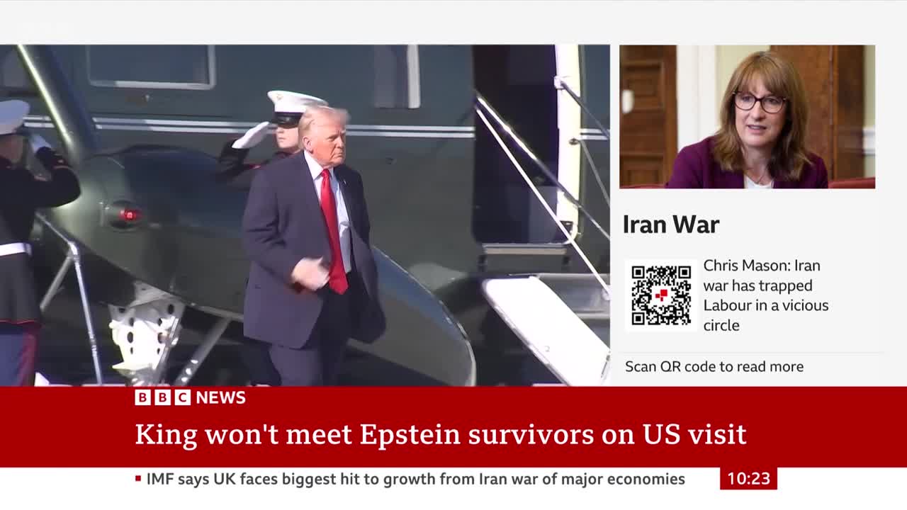 A man in a dark suit and red tie walks down a set of stairs from an aircraft, flanked by uniformed personnel. On a screen to the right, a woman with glasses speaks, with text overlaying the image about an "Iran War."